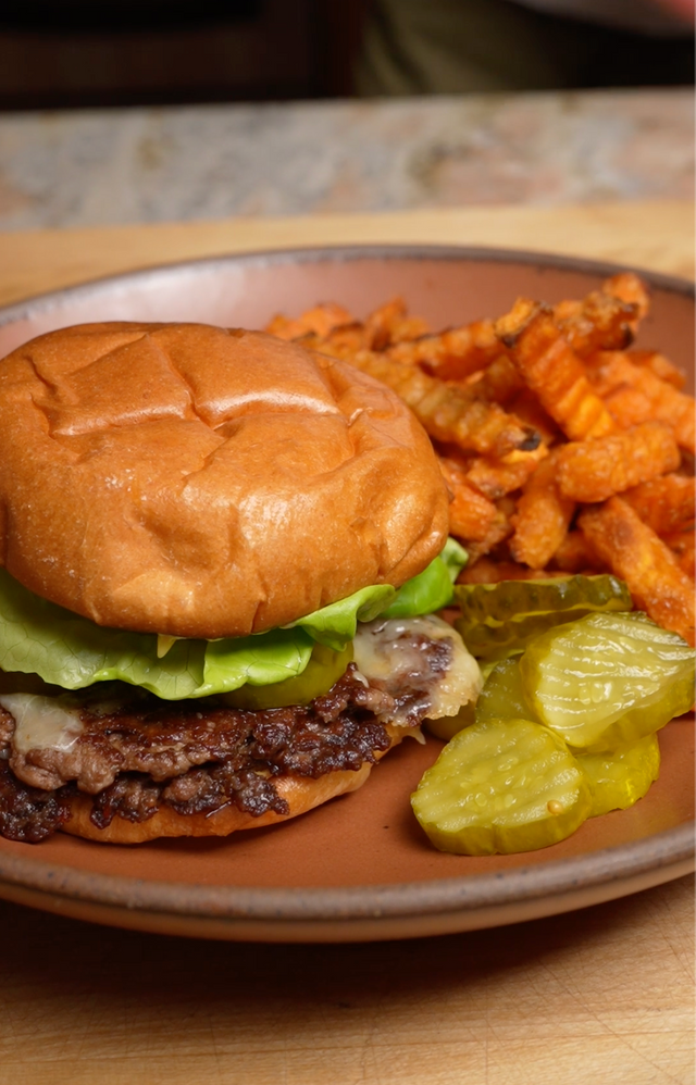 Smashburger with sweet potato fries and pickles